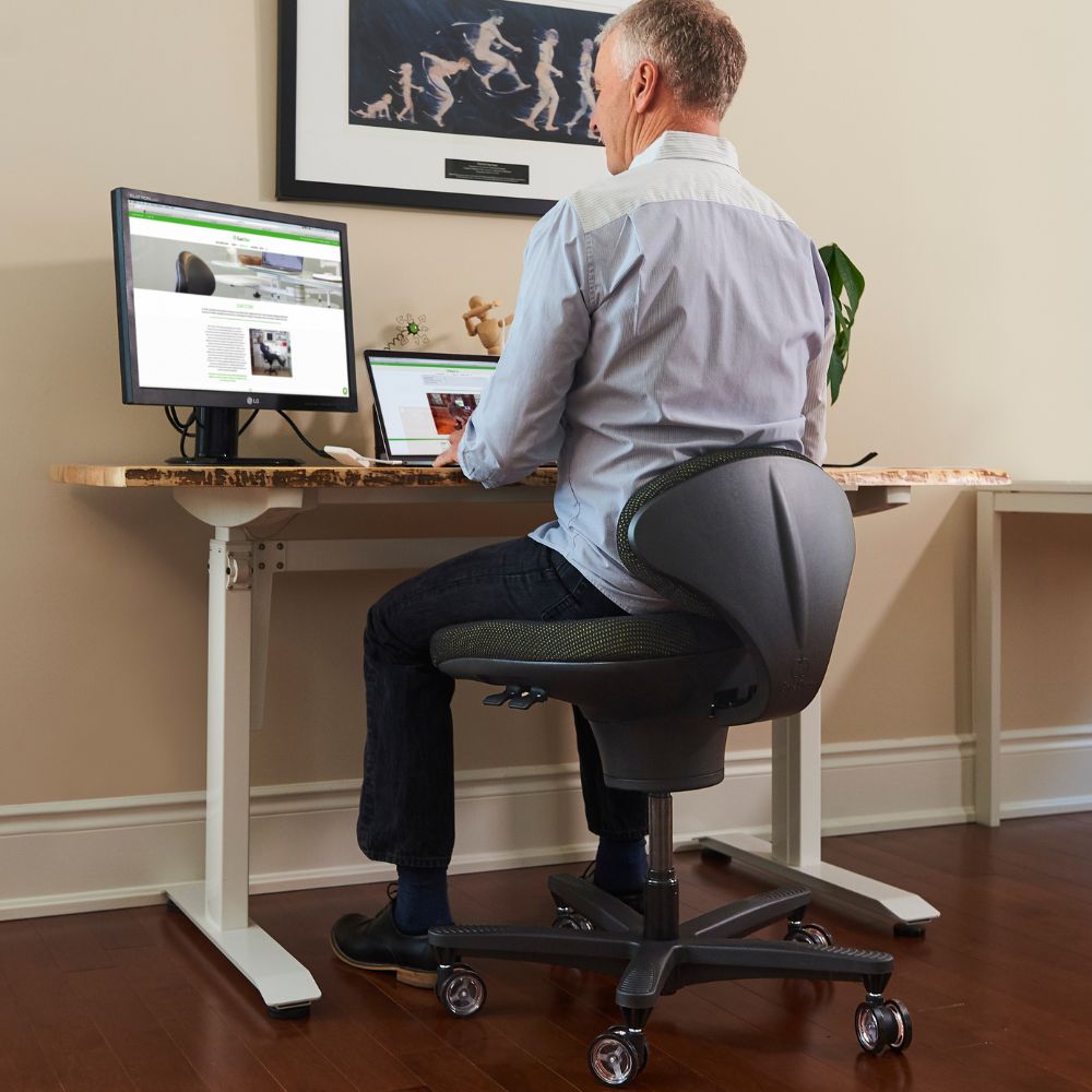 Man working at a standing desk on a Speckled Black CoreChair Classic
