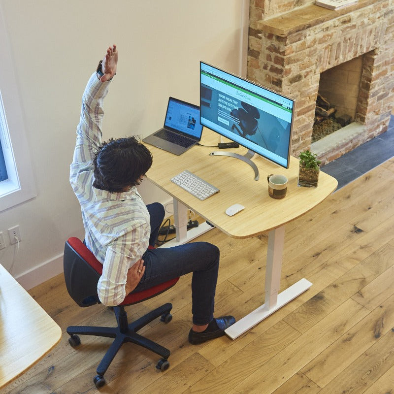 CoreChair Tango in Red with office stretching while seated from Active Goods Canada
