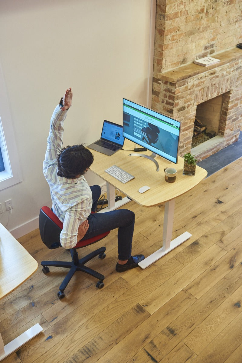 CoreChair Tango in Red with office stretching while seated from Active Goods Canada