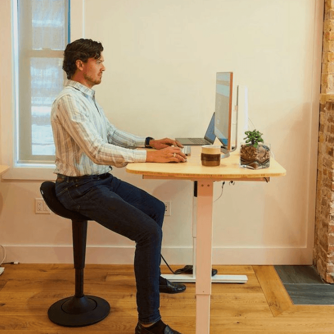 CorePerch Active Stool sitting down at office desk by Active Goods Canada