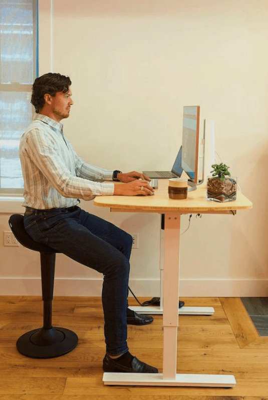 CorePerch Active Stool sitting down at office desk by Active Goods Canada