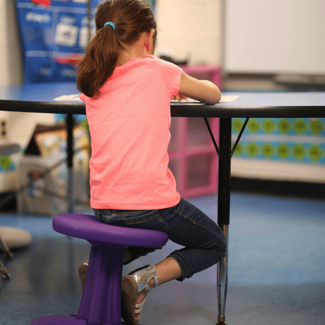 Girl using Kore Kids Wobble Chair 14" in classroom from Active Goods Canada