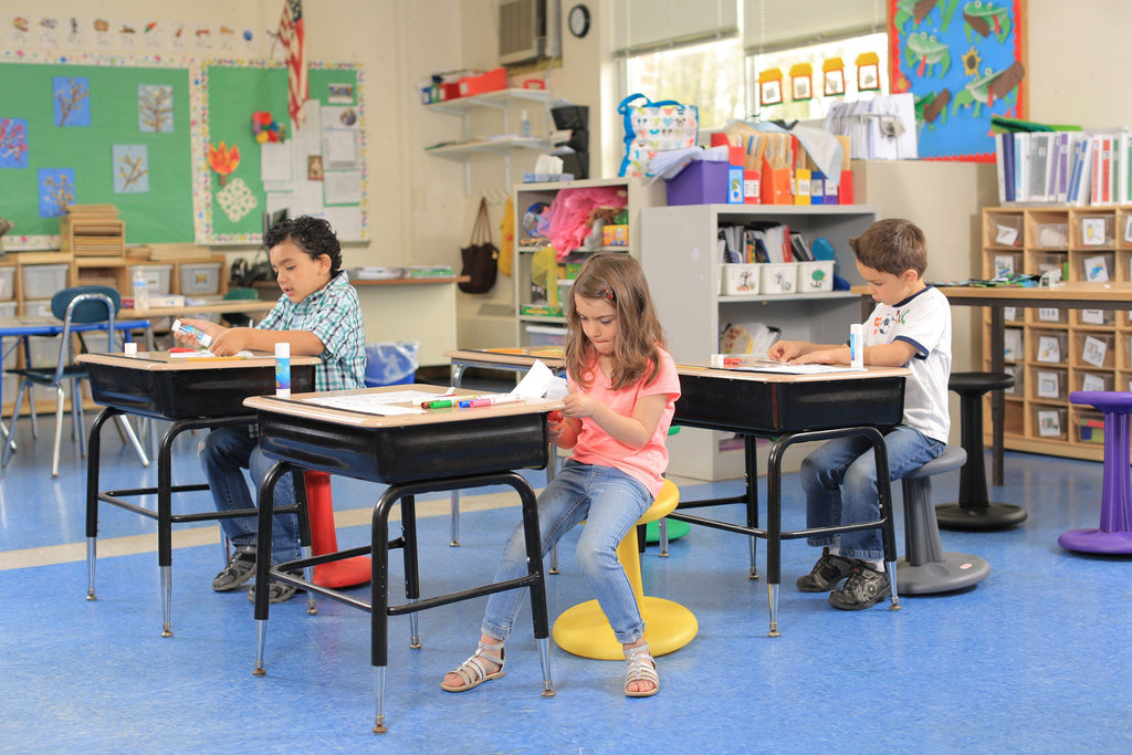 Children using Kore Pre-School Wobble Chair 12" in classroom from Active Goods Canada
