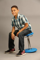 Boy using Kore Kids Height-Adjustable Wobble Chair from Active Goods Canada